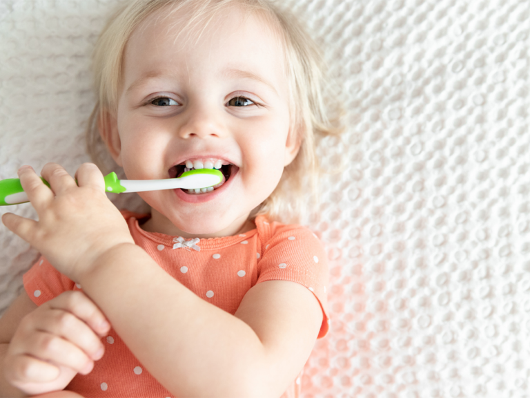 image of a little girl brushing her teeth